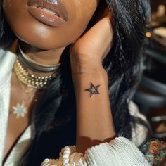 a woman with a star tattoo on her arm