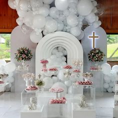 a room filled with white balloons and other decorations