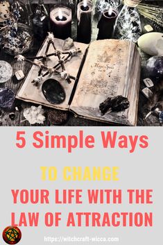 an open book with candles and other items surrounding it on top of a table that says 5 simple ways to change your life with the law of attraction