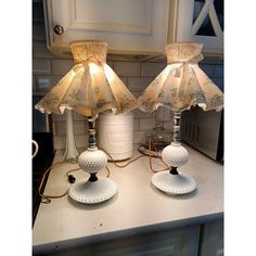 two lamps sitting on top of a counter