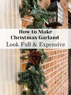 a christmas garland hanging on the side of a brick building with pine cones and greenery