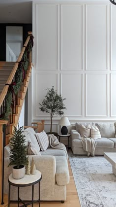 a living room filled with furniture and a christmas tree in the middle of the room