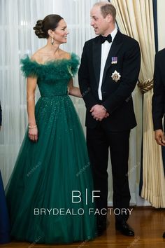 two people in formal wear standing next to each other