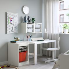 a child's room with a desk, chair and bookcase in white and blue