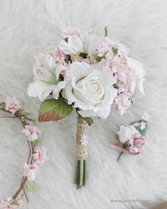 a bridal bouquet with white and pink flowers on a furnishing area,