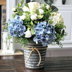 a vase filled with blue and white flowers