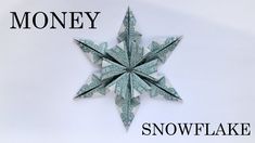 an origami snowflake made out of money