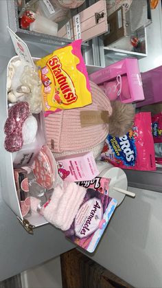 an open refrigerator door with candy, candies and other items on it's shelf