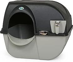 a grey and black cat litter box with the door open to reveal it's inner compartment