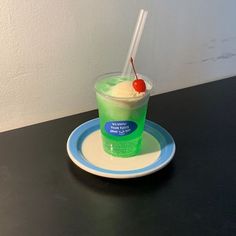 a green drink with a cherry on top