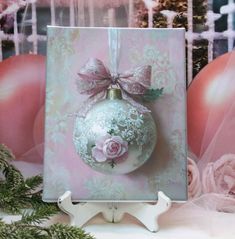 a christmas ornament with pink roses on it