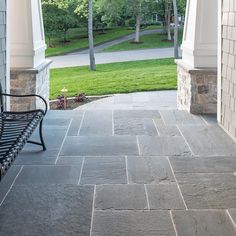 a bench sitting on top of a stone walkway