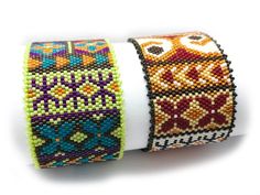 two bracelets with different designs on them