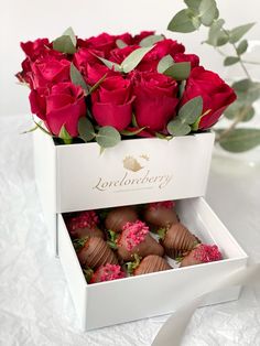 a white box filled with chocolate covered strawberries