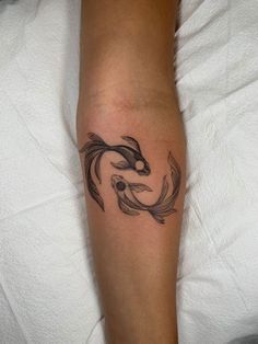 a tattoo on the leg of a person with a koi fish design on it