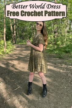 a woman standing in the middle of a dirt road wearing black boots and a green dress