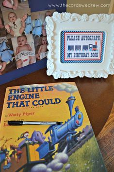 there are two books on the table and one is in front of a birthday cake