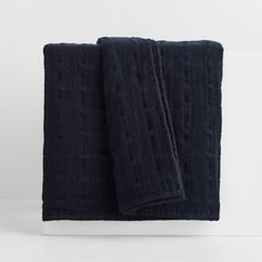 two dark blue towels folded on top of each other