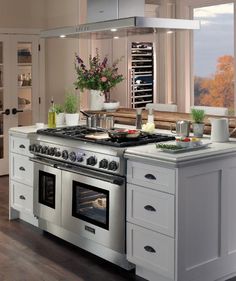 a large kitchen with an oven, stove and cabinets in it's center island