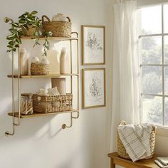 a shelf filled with vases and other items next to a window in a room