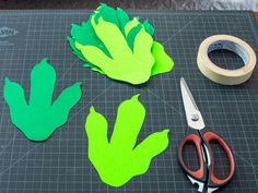 some cut up vegetables sitting on top of a cutting board next to scissors and tape