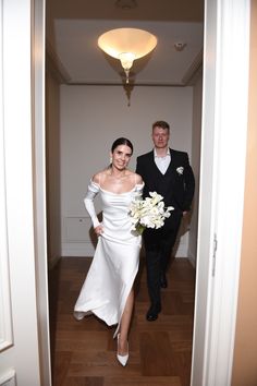 the bride and groom are walking down the hall