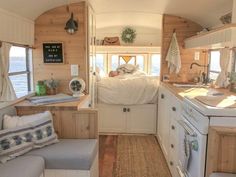 a kitchen and living room inside of a small home with wood paneling on the walls