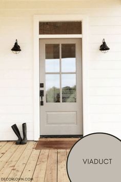 a white front door with the words viaduct over it and an image of black boots