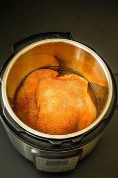 an open crock pot filled with food on top of a table