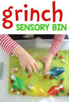 a close up of a child's hands in a plastic bin filled with toys