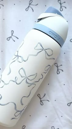 a white and blue water bottle sitting on top of a bed