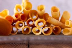 several pieces of pasta sitting on top of a wooden table