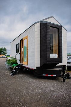 a tiny house is parked in the parking lot