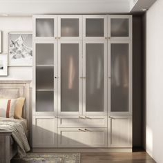 a bedroom with a bed, dresser and glass doors on the closets in it