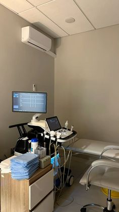 a hospital room with two monitors and medical equipment