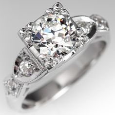 This vintage engagement ring is centered with an old European cut diamond weighing 0.90 carat and set high into a four-prong illusion style head. The shoulders of the ring are each accented with two (2), bead set, old European cut diamonds, bordered with milgrain edging. The ring measures 7.1mm at the top, rises 8.5mm above the finger, tapering to 2.7mm wide and 1.2mm thick at the base of the shank. The ring is currently a size 4 and we offer complimentary resizing to fit. High Setting Engagement Ring, Setting Engagement Ring, Antique Diamond Rings, Vintage Engagement Ring, Diamond Engagement Rings Vintage, Bead Set, Wide Band Rings, European Cut Diamonds, Emerald Jewelry