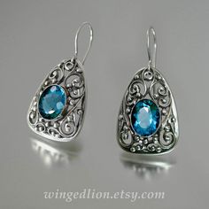 GERTRUDE silver earrings with London Blue Topaz by WingedLion Blue Sterling Silver Earrings With Intricate Design, Sterling Silver Blue Earrings With Intricate Design, Luxury Sterling Silver Filigree Earrings, Silver Topaz Teardrop Earrings, Silver Teardrop Topaz Earrings, Ornate Silver Blue Topaz Jewelry, Sterling Silver Earrings With Intricate Design, Ornate Sterling Silver Gemstone Earrings, Exquisite Sterling Silver Earrings With Intricate Design