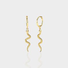 Embrace the trend with our "Hiss" earrings – featuring a small hoop with a dangling snake for a touch of mystique. These earrings capture the allure of serpentine elegance and add a bold statement to your look. The snakes are back, and they're ready to slither into your style with the chic charm of our "Hiss" earrings. 925 Sterling Silver 18k Gold Plated Nickel Free & Hypoallergenic Snake Shape Earrings For Party, Elegant Snake Shape Earrings With Ear Wire, Elegant Yellow Gold Snake Earrings, Gold Snake Earrings For Party, Trendy Snake-shaped Earrings For Gifts, Elegant Snake-shaped Single Earring, Adventure Style, Earring Sale, The Trend