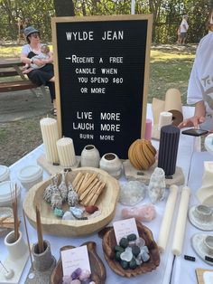 a table topped with lots of different types of items on top of a white table cloth