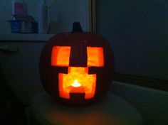 a pumpkin carved to look like a jack - o'- lantern sitting on top of a counter