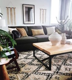 a living room filled with lots of furniture next to a large window on top of a rug