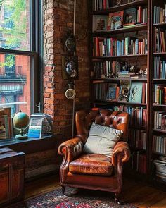 a leather chair sitting in front of a book shelf filled with books