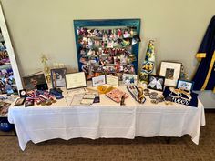 a table with many items on it in front of a flag and other memorabilias