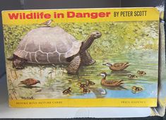 an old children's book about wildlife in danger by peter scott on a wooden fence