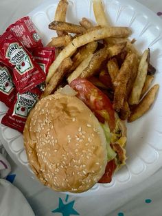 a hamburger and french fries on a paper plate