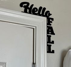 there is a sign that says hello fall on the wall next to an open door