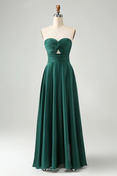 a green dress on a mannequin dummy with the back cut out and straps down