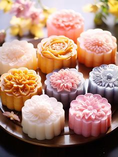 various soaps on a plate with flowers in the background