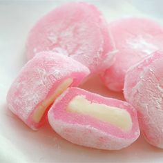 some pink and white candy pieces on a table