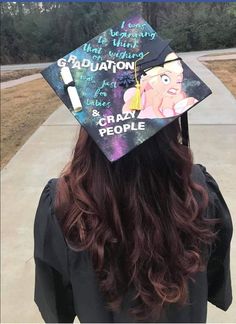 a person wearing a graduation cap with writing on it